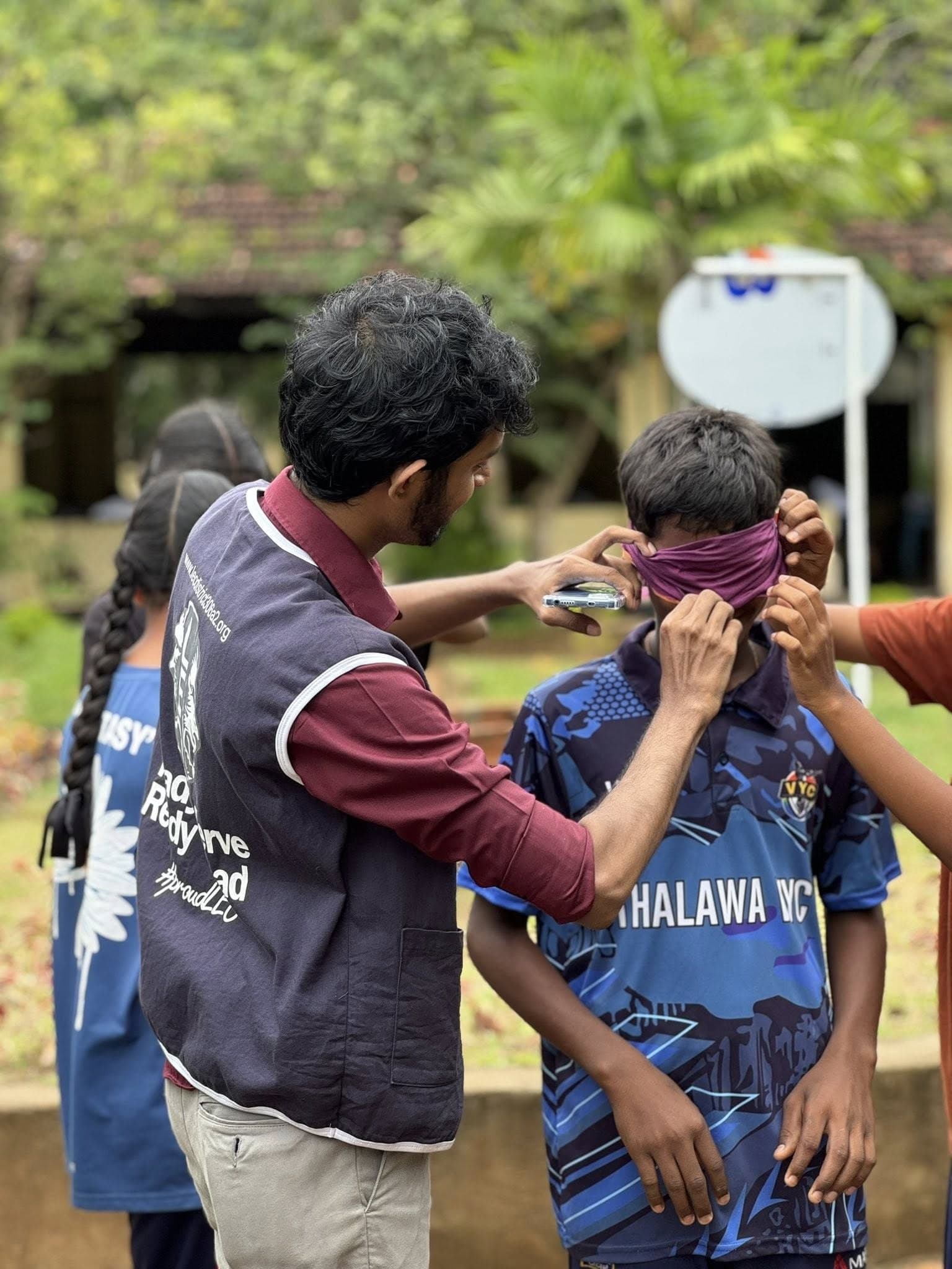 A Leo helping a child at a village service project